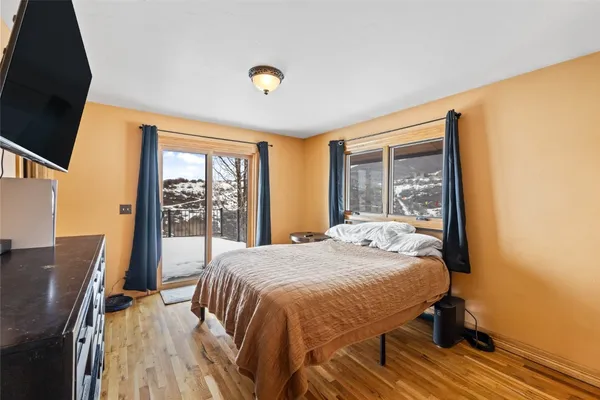 a bedroom with a bed and a flat screen tv