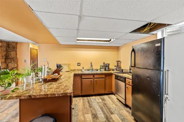 a kitchen with sink cabinets and wooden floor