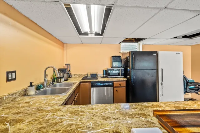 a bedroom with a bed and large windows