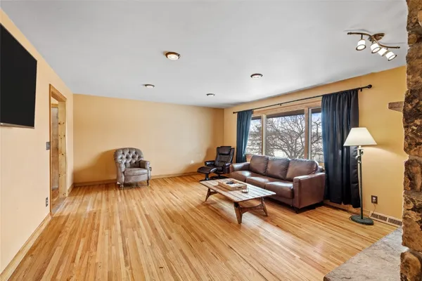 a kitchen with stainless steel appliances a table chairs refrigerator and microwave