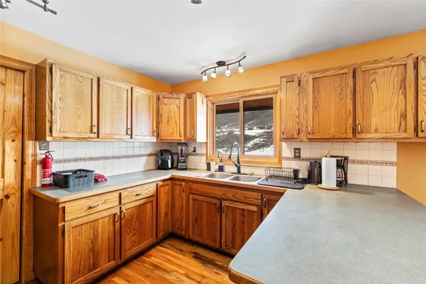 a kitchen with a refrigerator and a stove top oven