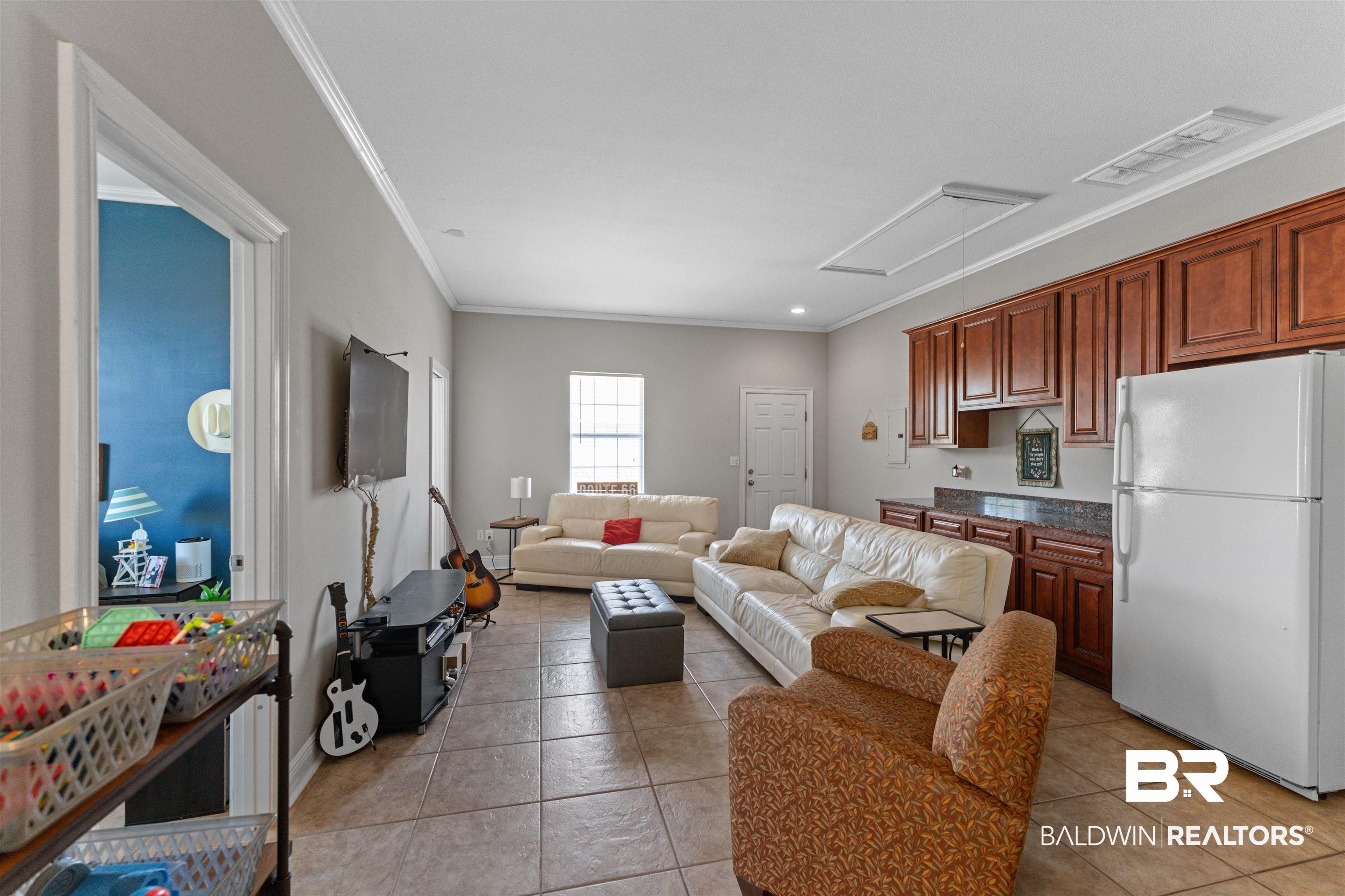 12664 Hunters Chase Foley, AL 36535 - Photo 27 of 62 Living room with ornamental molding and light tile patterned flooring