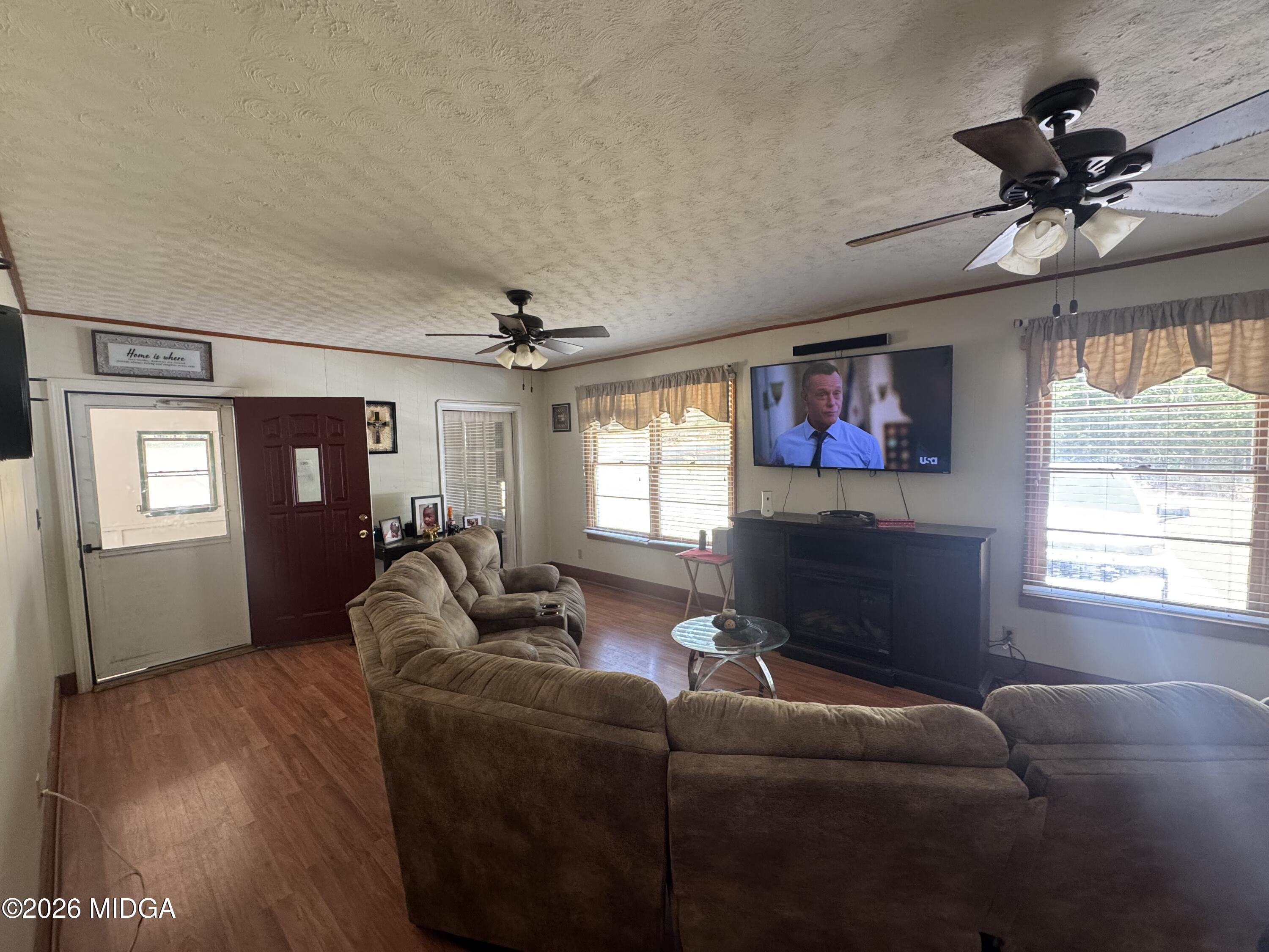 558 Old Brent Road Forsyth, GA 31029 - Photo 2 of 9 a living room with furniture and a flat screen tv