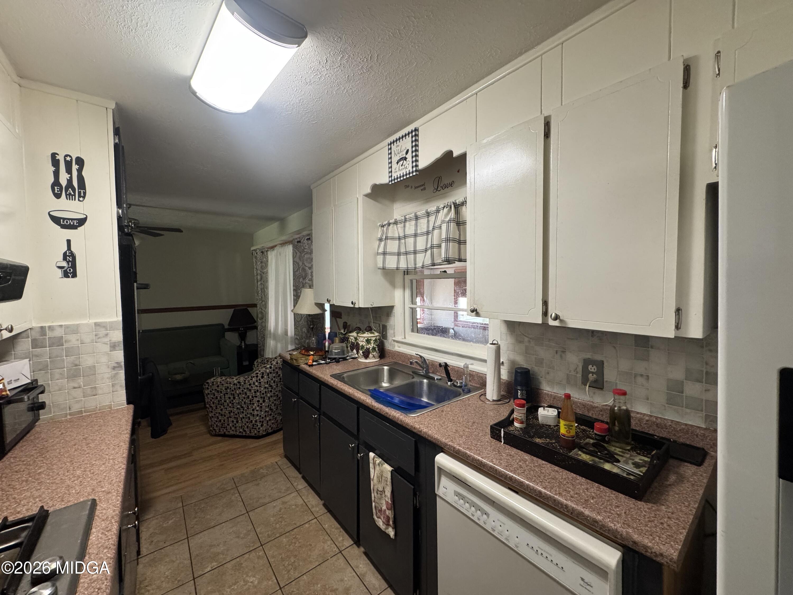 558 Old Brent Road Forsyth, GA 31029 - Photo 6 of 9 a kitchen with stainless steel appliances a stove a sink and a refrigerator