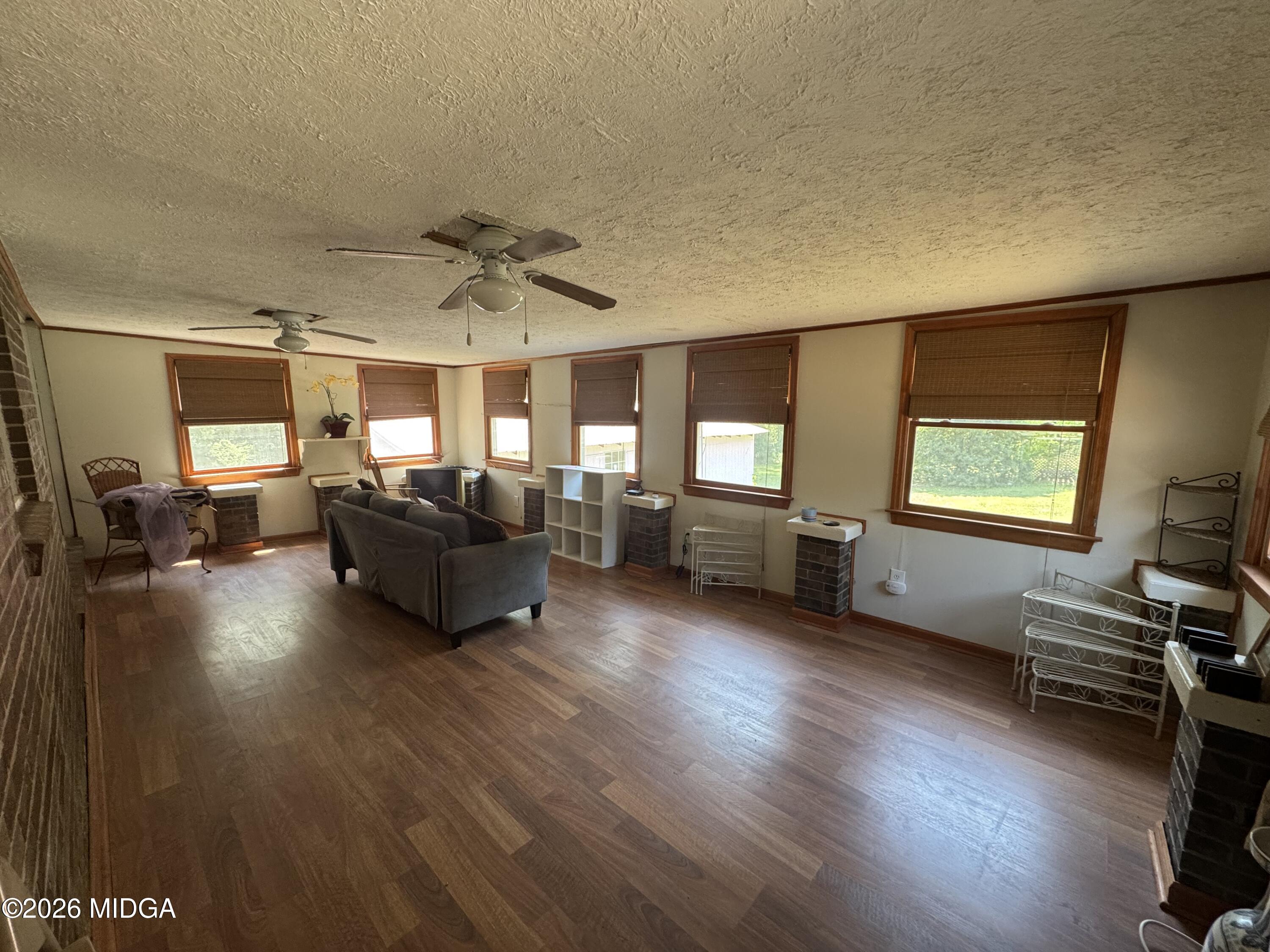 558 Old Brent Road Forsyth, GA 31029 - Photo 8 of 9 a living room with furniture and a wooden floor