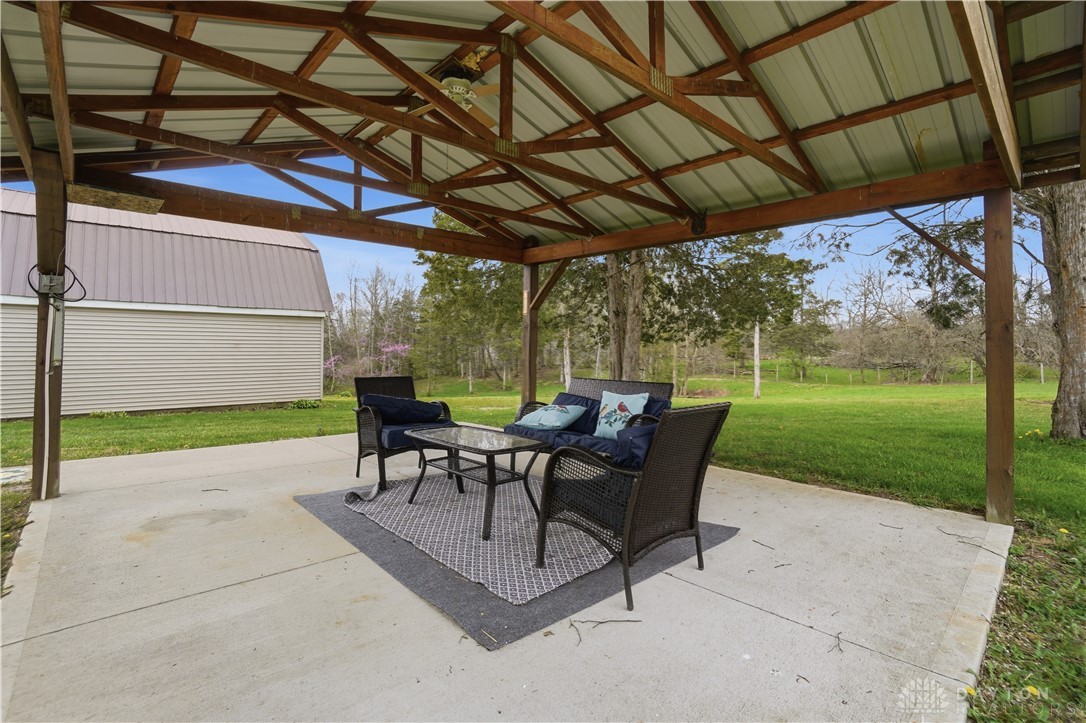 7553 Coffin Station Road Springfield, OH 45502 - Photo 18 of 95 This covered patio offers an inviting outdoor relaxation space with views of the expansive yard.