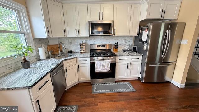 7907 Subet Road Windsor Mill, MD 21244 - Photo 6 of 31 a kitchen with granite countertop a refrigerator stove and microwave
