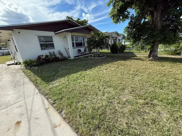 a view of house with yard