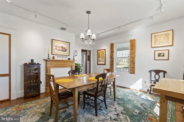 a view of a dining room with furniture and a chandelier