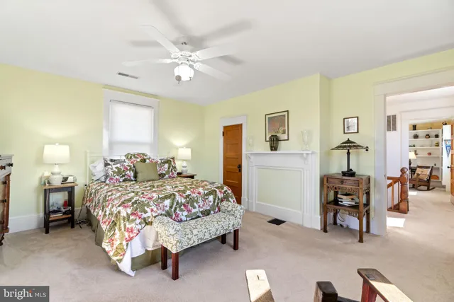 a bedroom with bed and a chandelier
