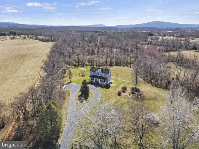 an aerial view of residential house with swimming pool and mountain view