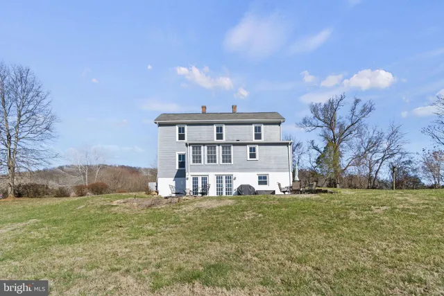 a large building with a big yard and large trees