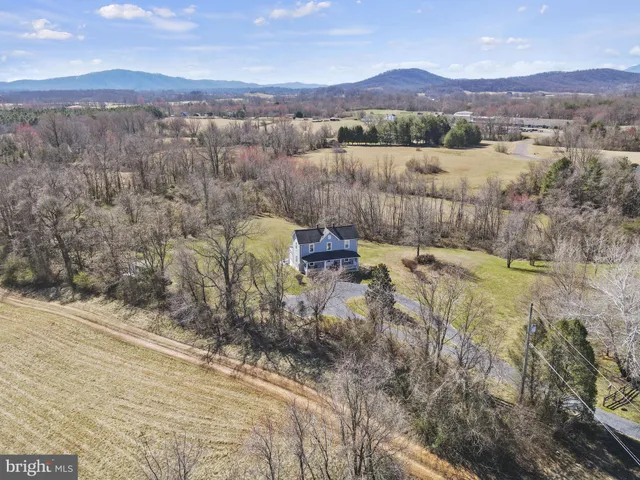 a view of a lush green hillside and houses