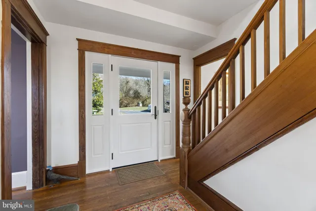 a view of an entryway with wooden floor