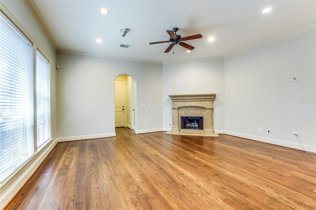 5630 Ellsworth Avenue Dallas, TX 75206 - Photo 12 of 25 a view of empty room with wooden floor and fireplace