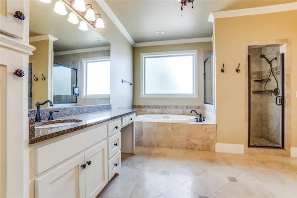 a bathroom with a granite countertop sink mirror and a bathtub