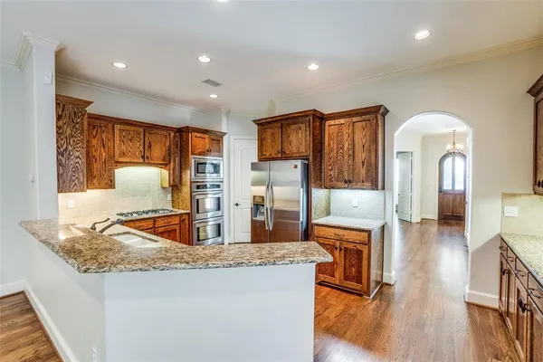 a living room with stainless steel appliances kitchen island granite countertop furniture and a kitchen view