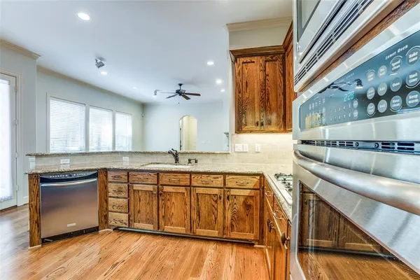 a kitchen with a sink cabinets and wooden floor