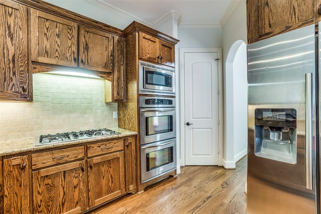 5630 Ellsworth Avenue Dallas, TX 75206 - Photo 10 of 25 a kitchen with stainless steel appliances granite countertop a stove and a refrigerator