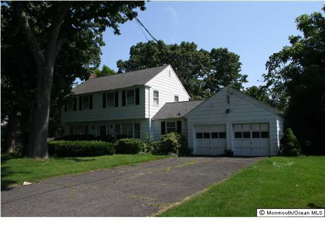 95 Hance Road Fair Haven, NJ 07704 - Photo 2 of 3 a black and white house in front of a yard with many windows