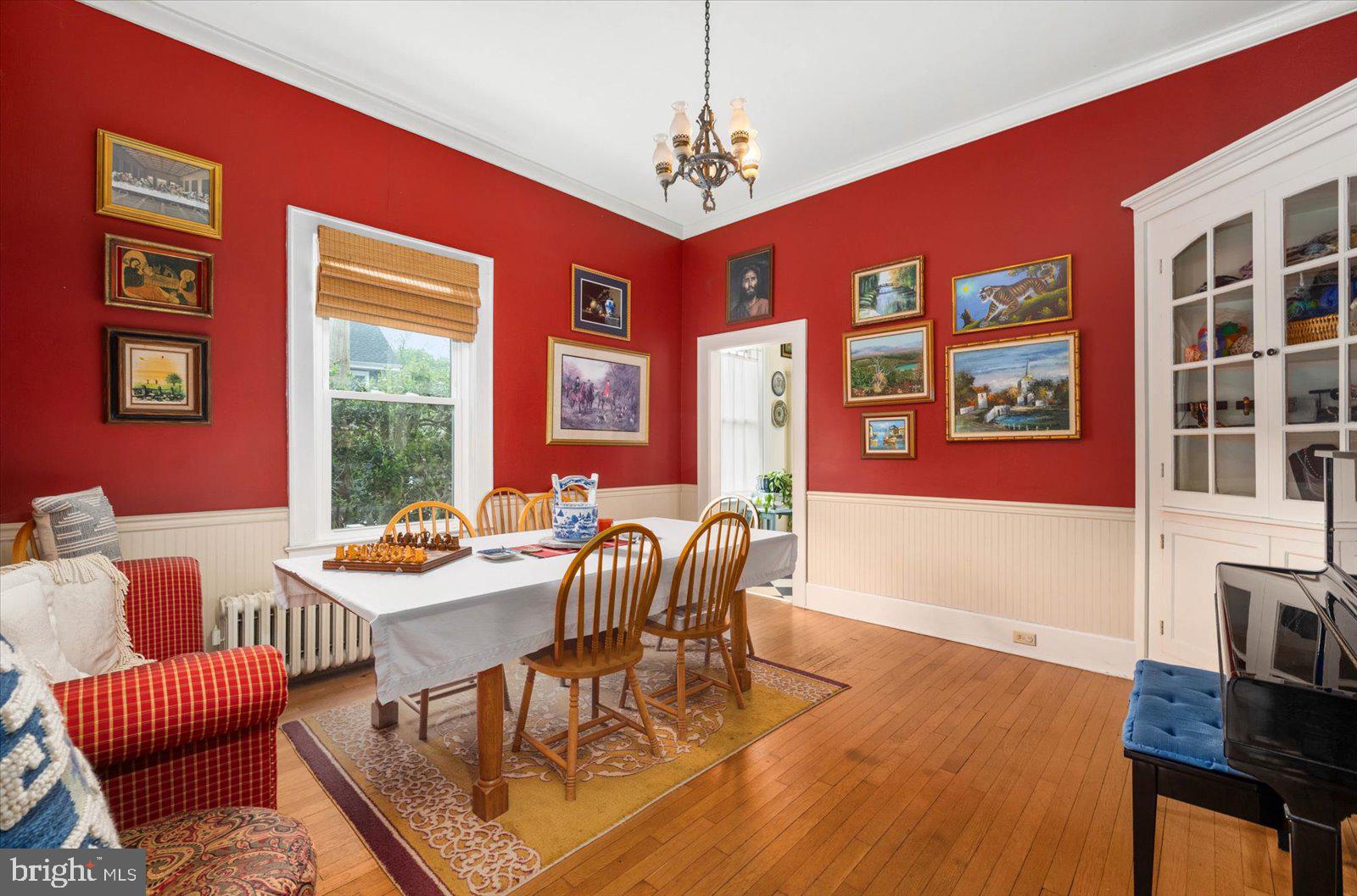 4 Washington Street Berlin, MD 21811 - Photo 16 of 125 a dining room with furniture a floor to ceiling window and wooden floor