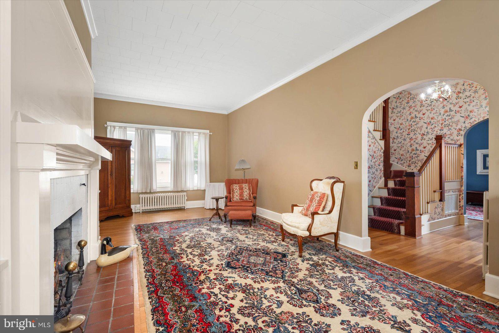 4 Washington Street Berlin, MD 21811 - Photo 64 of 125 a living room with furniture a fireplace and a chandelier