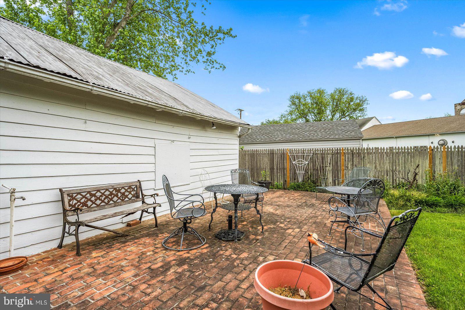4 Washington Street Berlin, MD 21811 - Photo 94 of 125 a patio with table and chairs and potted plants