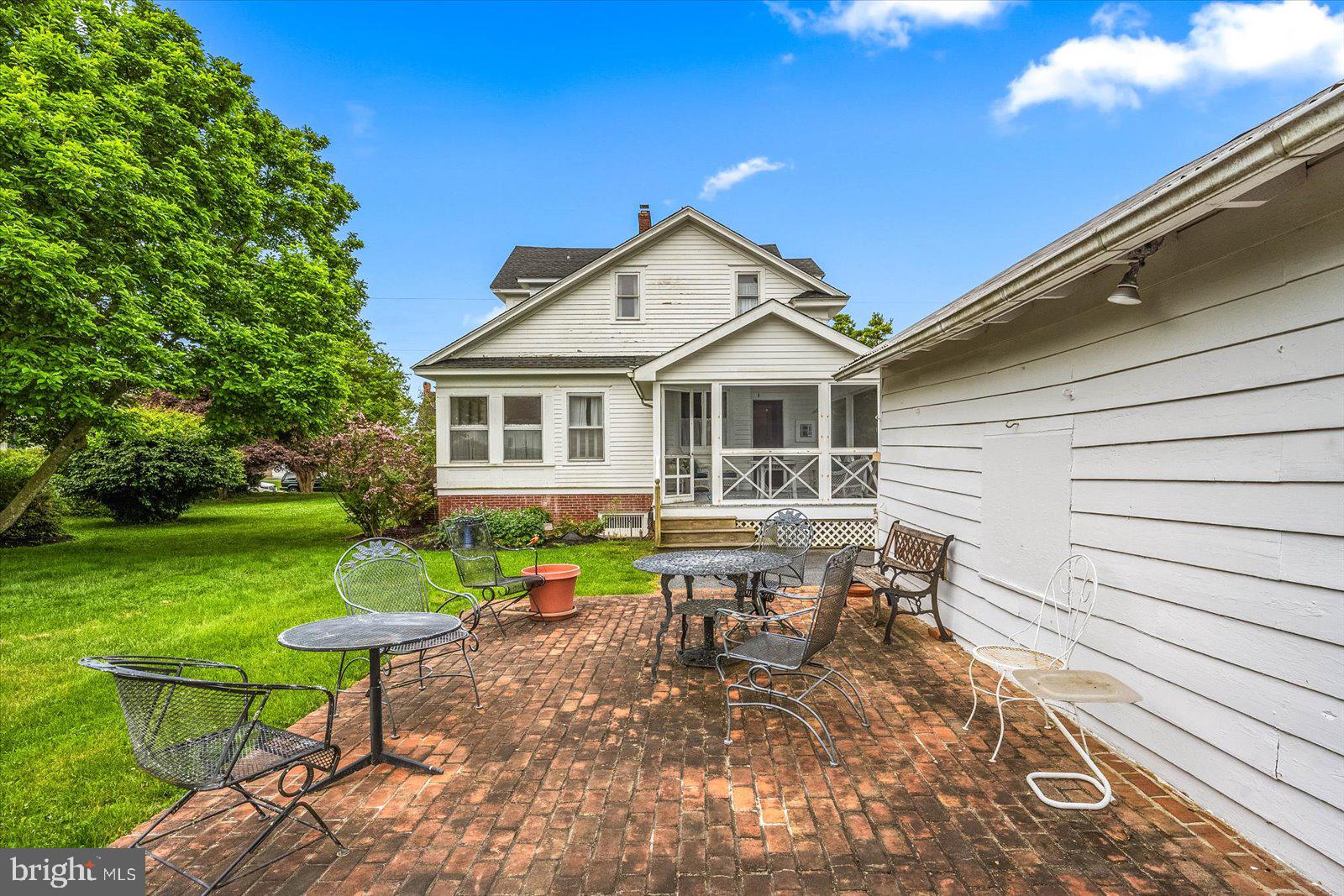 4 Washington Street Berlin, MD 21811 - Photo 95 of 125 a view of a house with a yard chairs and table in a patio