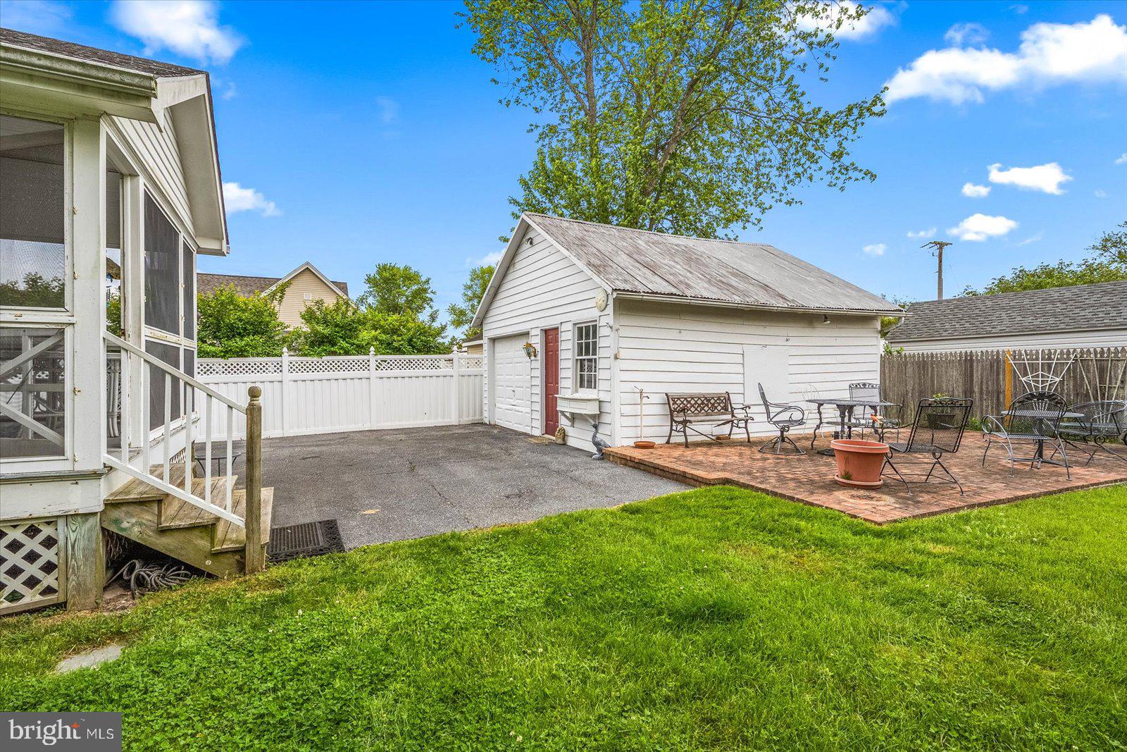4 Washington Street Berlin, MD 21811 - Photo 100 of 125 a front view of house with a garden and patio