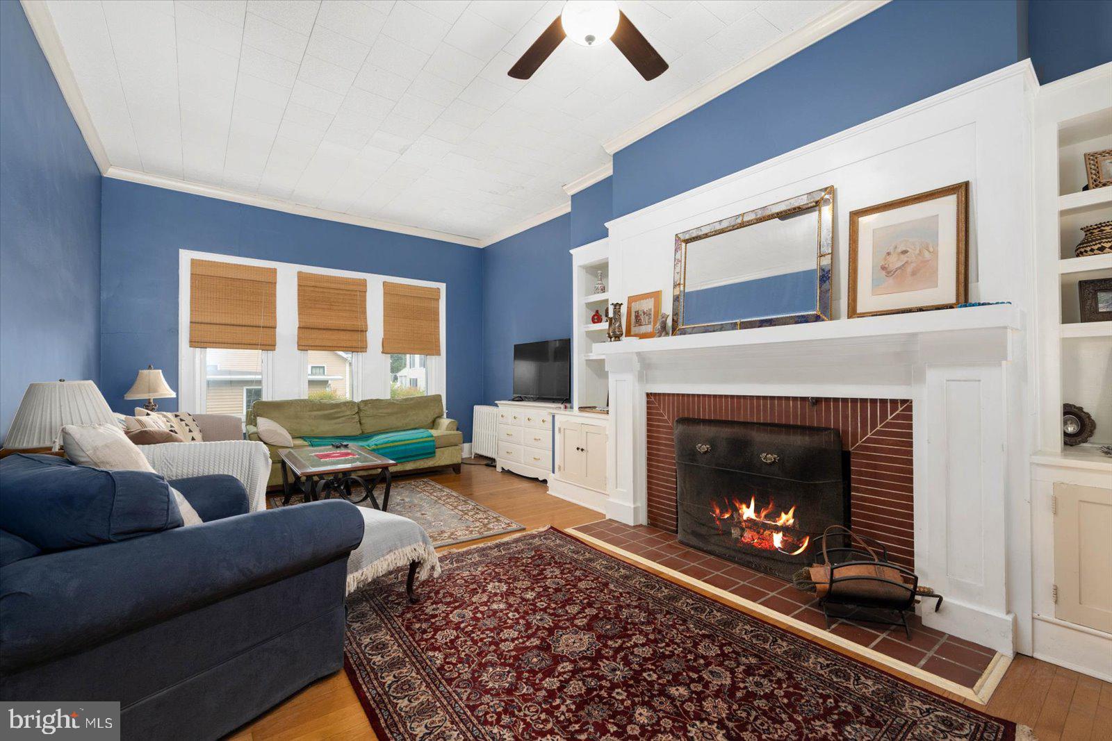 4 Washington Street Berlin, MD 21811 - Photo 10 of 125 a living room with furniture a window and a fireplace