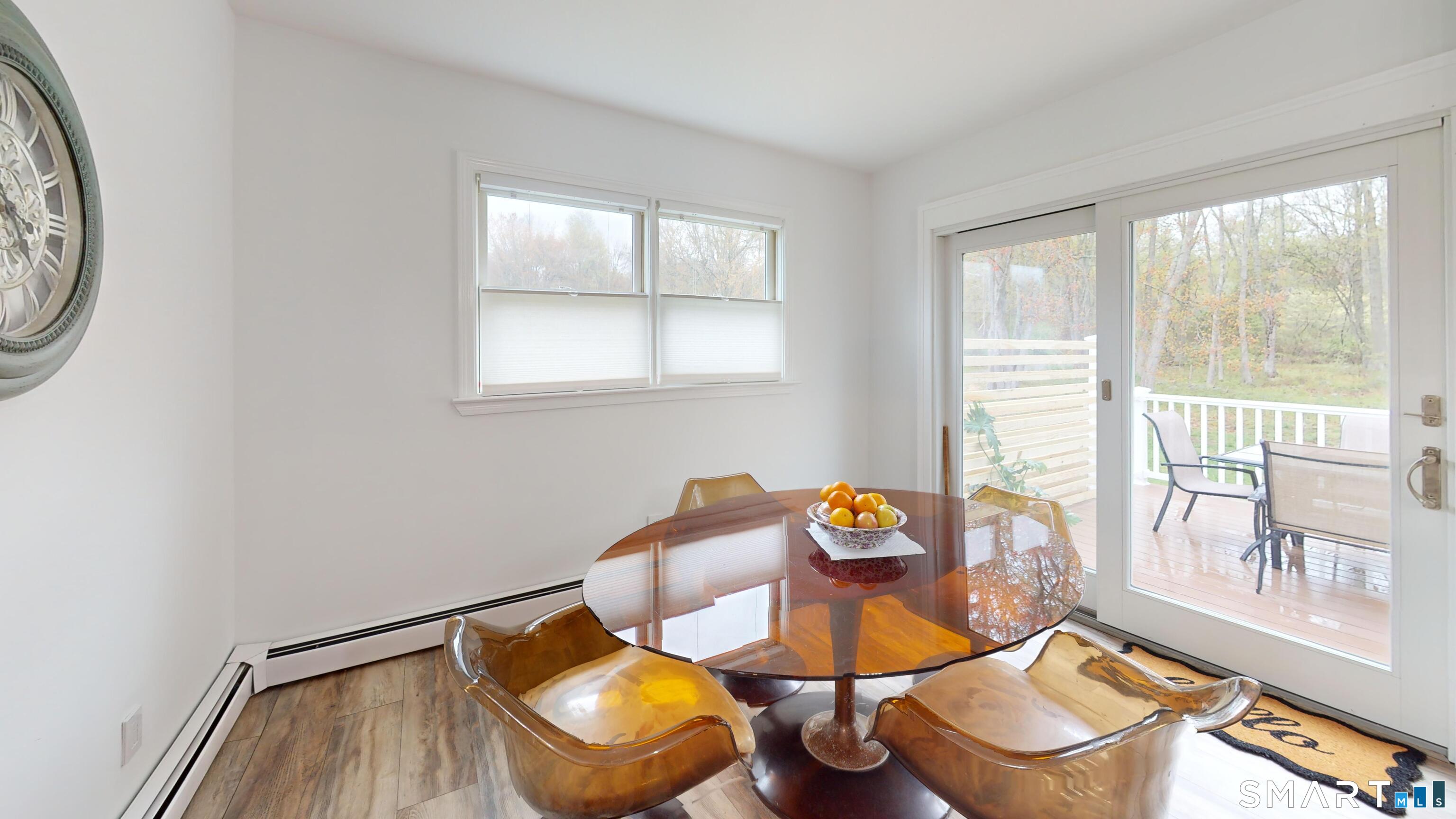 29 Deer Ridge Road Stonington, CT 06378 - Photo 20 of 35 a view of a dining room with furniture a chandelier and wooden floor