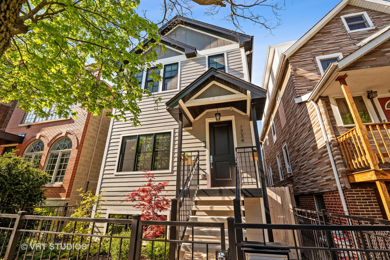 1734 West Henderson Street Chicago, IL 60657 - Photo 1 of 24 a front view of a house with a yard