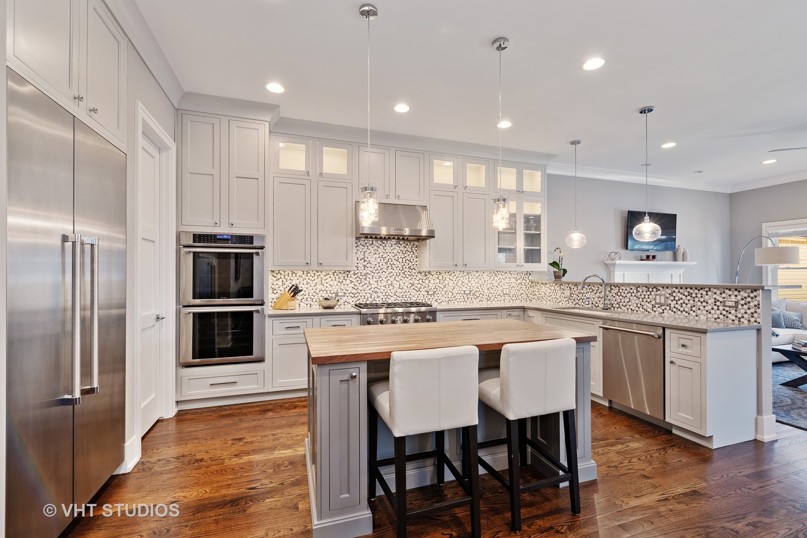 1734 West Henderson Street Chicago, IL 60657 - Photo 4 of 24 a kitchen with stainless steel appliances granite countertop a kitchen island a stove a table and chairs
