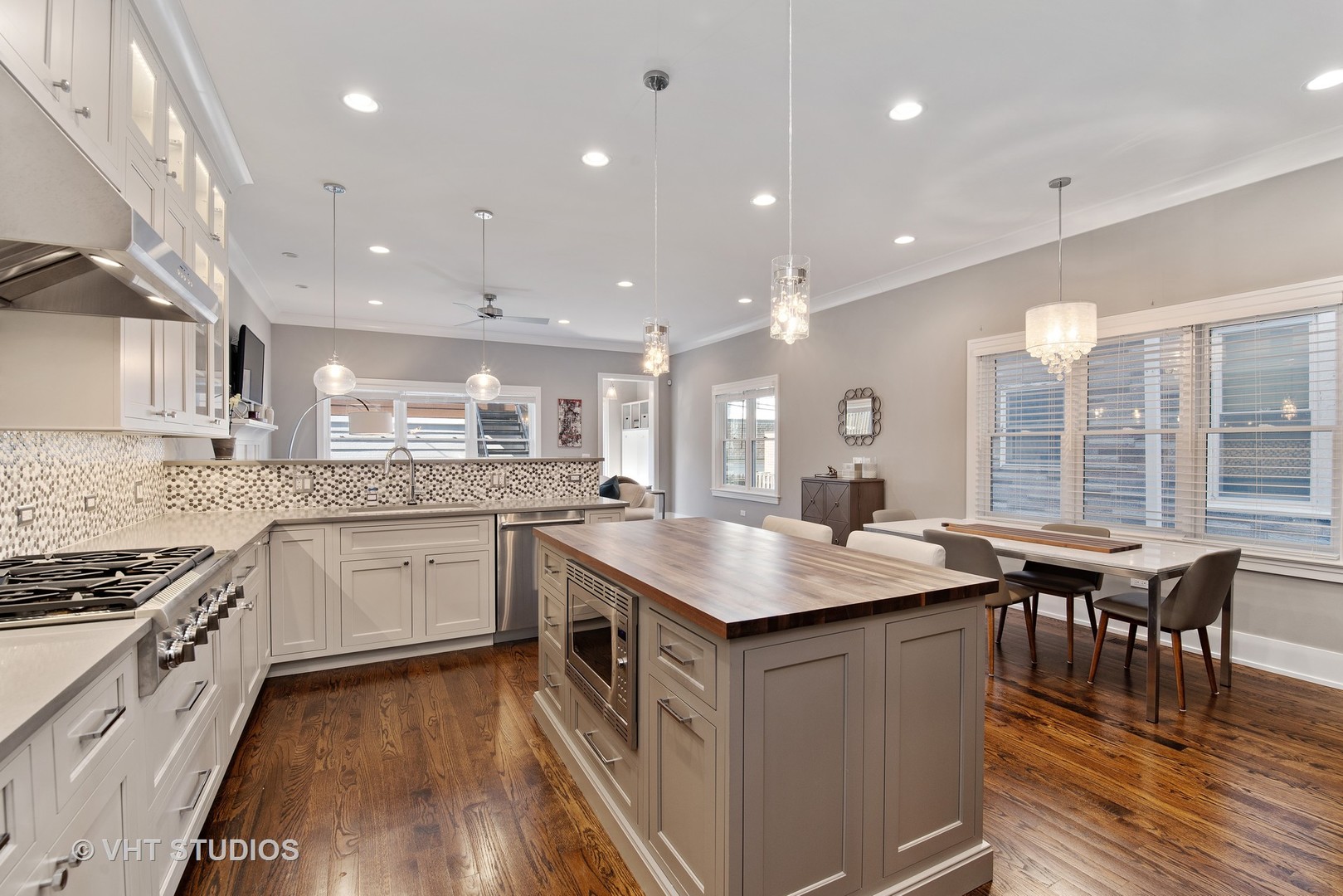 1734 West Henderson Street Chicago, IL 60657 - Photo 5 of 24 a kitchen with granite countertop a sink a counter top space stainless steel appliances and cabinets