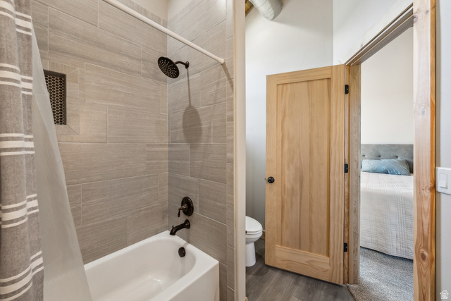46997 West Thunder Road Fruitland, UT 84027 - Photo 26 of 49 Ensuite bathroom featuring shower / tub combo with curtain and wood finished floors