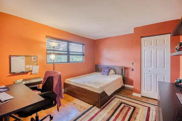 a bedroom with a bed and a desk
