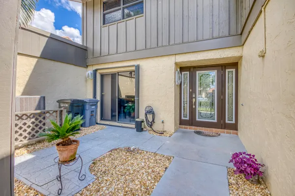 a dining room with furniture and a potted plant