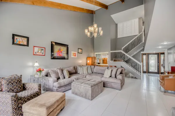 a living room with furniture and a chandelier