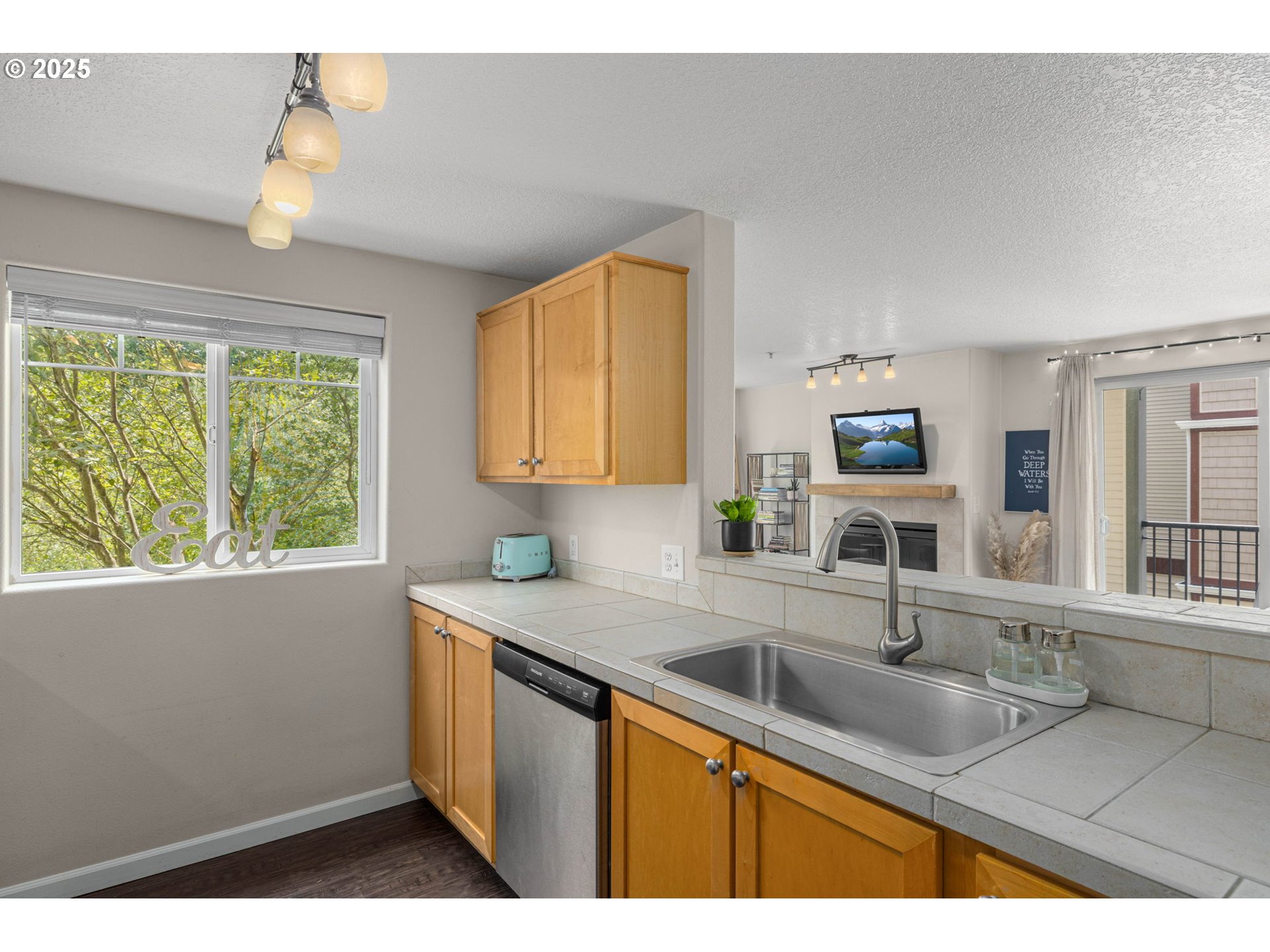 780 Northwest 185th Avenue, Unit 207 Beaverton, OR 97006 - Photo 13 of 29 a kitchen with a sink granite counter tops and a window