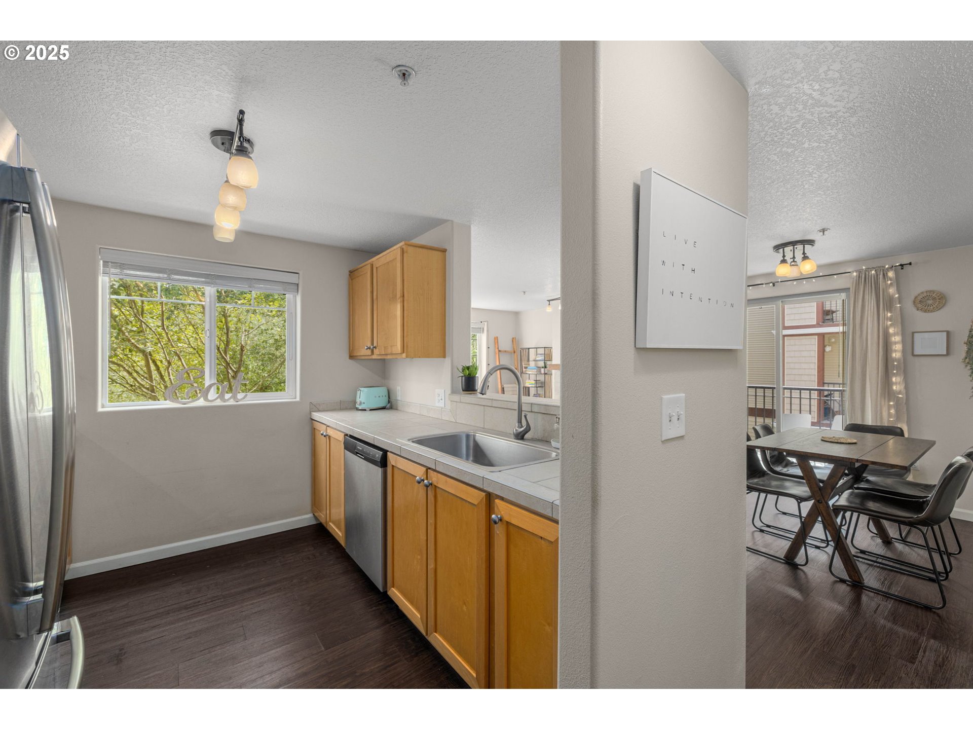 780 Northwest 185th Avenue, Unit 207 Beaverton, OR 97006 - Photo 14 of 29 a kitchen with sink cabinets and dining table