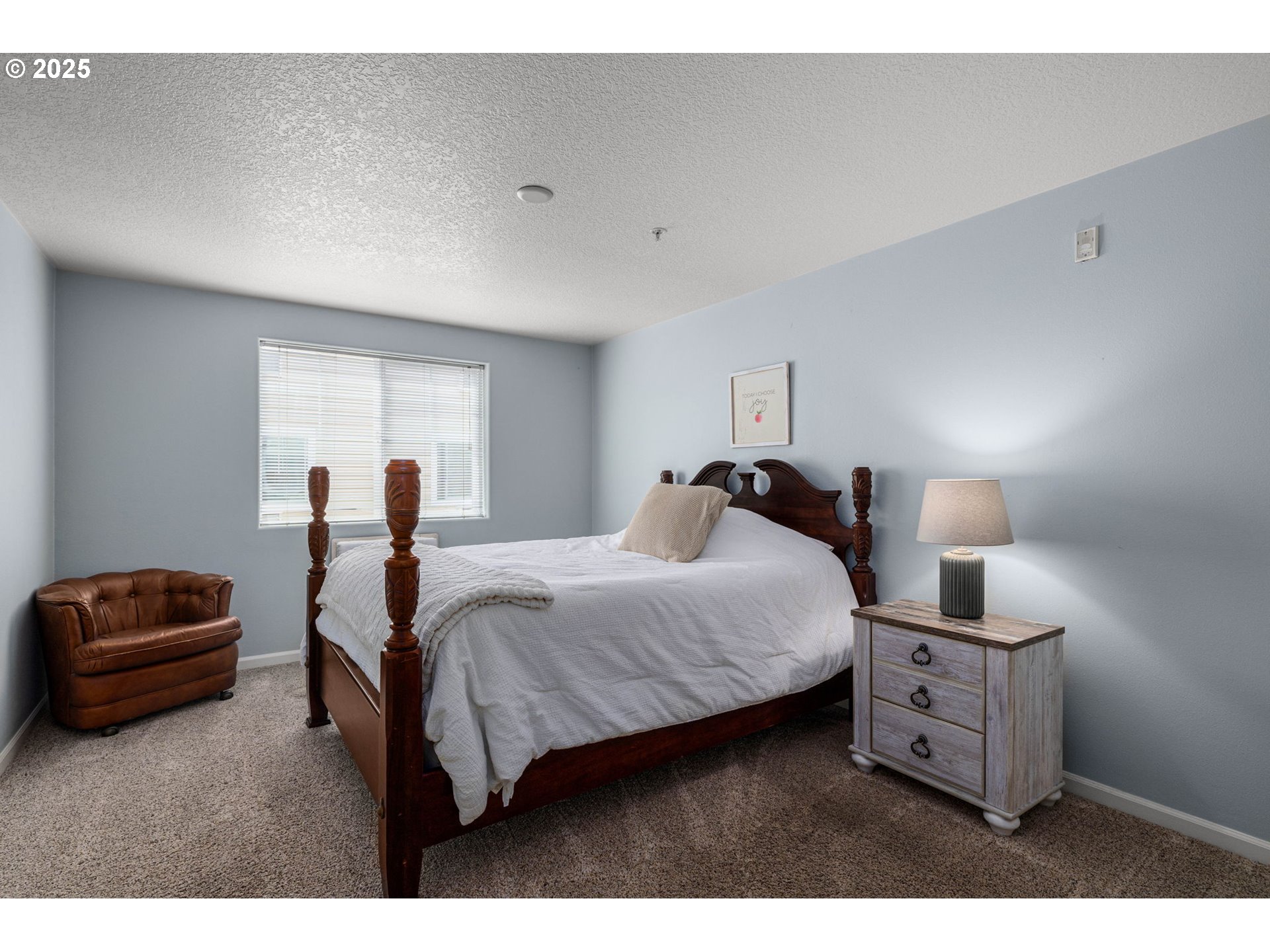 780 Northwest 185th Avenue, Unit 207 Beaverton, OR 97006 - Photo 15 of 29 a bedroom with a bed and a lamp