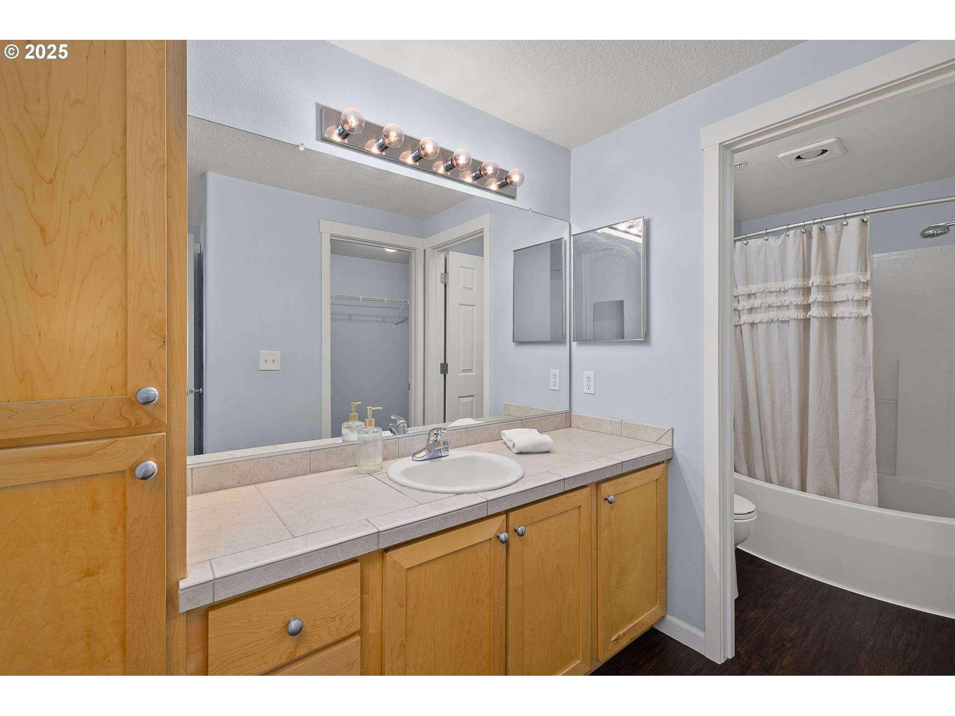 780 Northwest 185th Avenue, Unit 207 Beaverton, OR 97006 - Photo 17 of 29 a bathroom with a sink a mirror and a shower