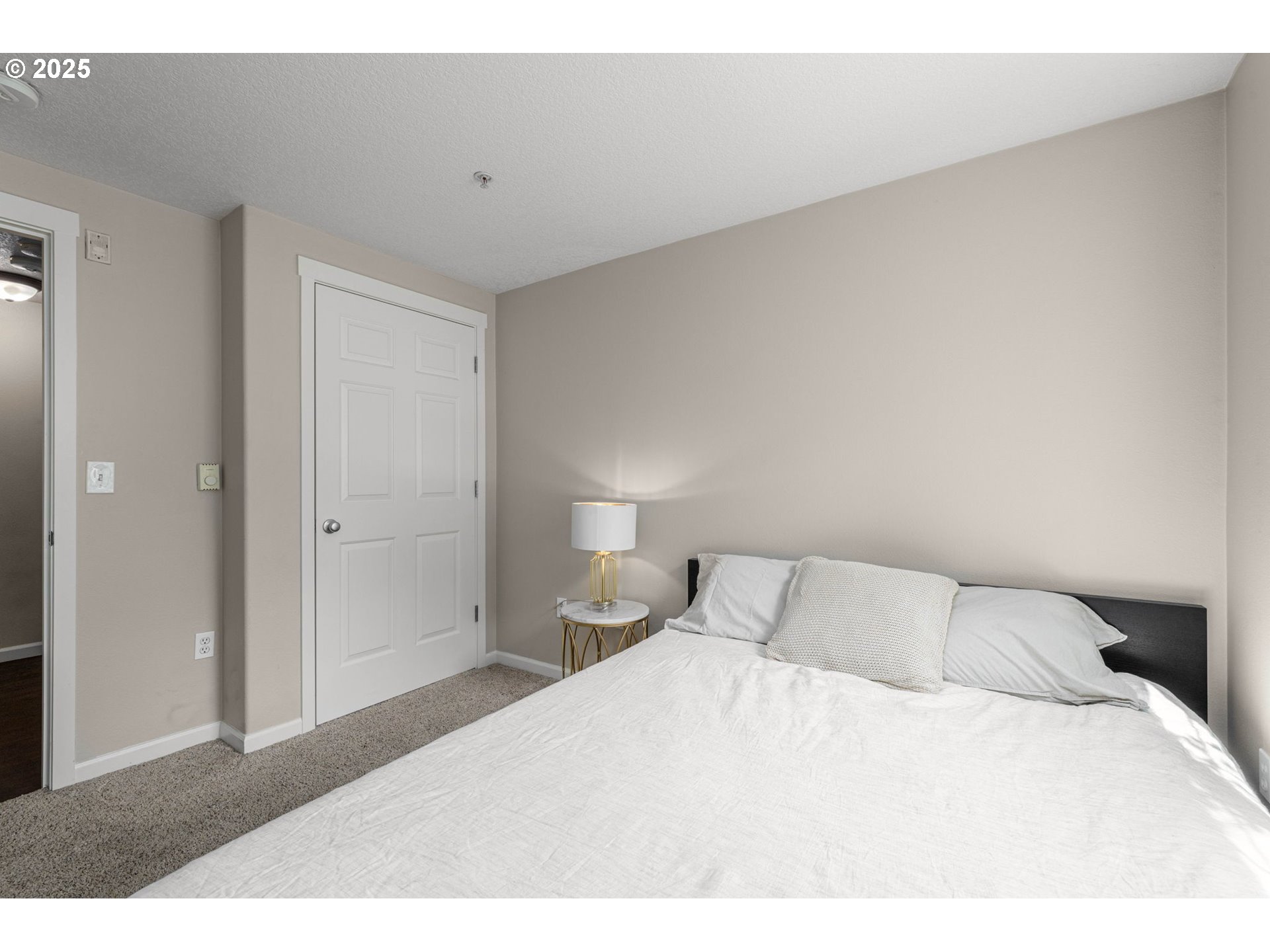 780 Northwest 185th Avenue, Unit 207 Beaverton, OR 97006 - Photo 21 of 29 a bedroom with a bed and a night stand