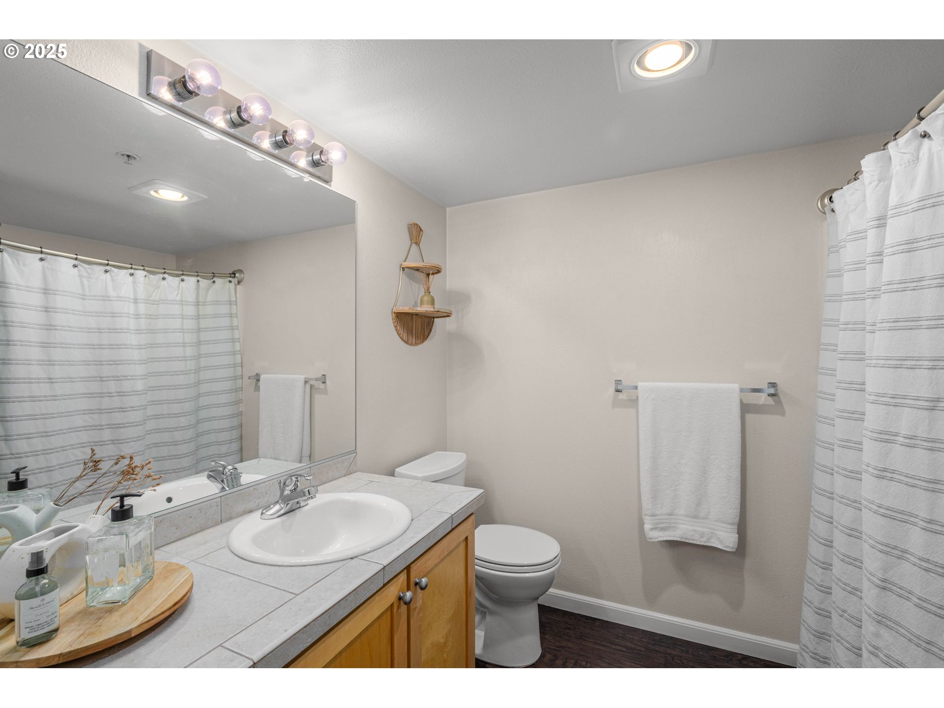 780 Northwest 185th Avenue, Unit 207 Beaverton, OR 97006 - Photo 25 of 29 a bathroom with a sink a toilet and mirror