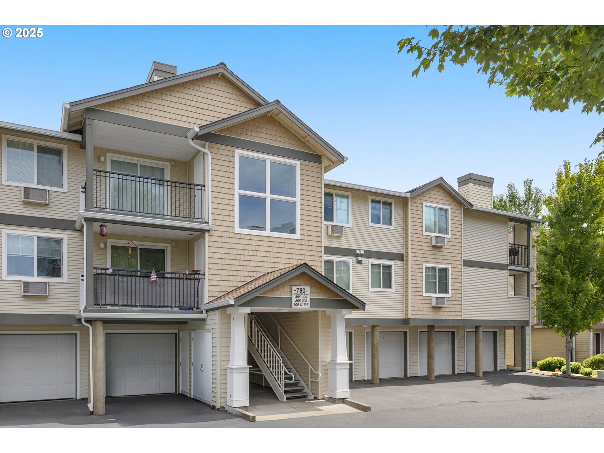 780 Northwest 185th Avenue, Unit 207 Beaverton, OR 97006 - Photo 27 of 29 a front view of a house with a yard and garage