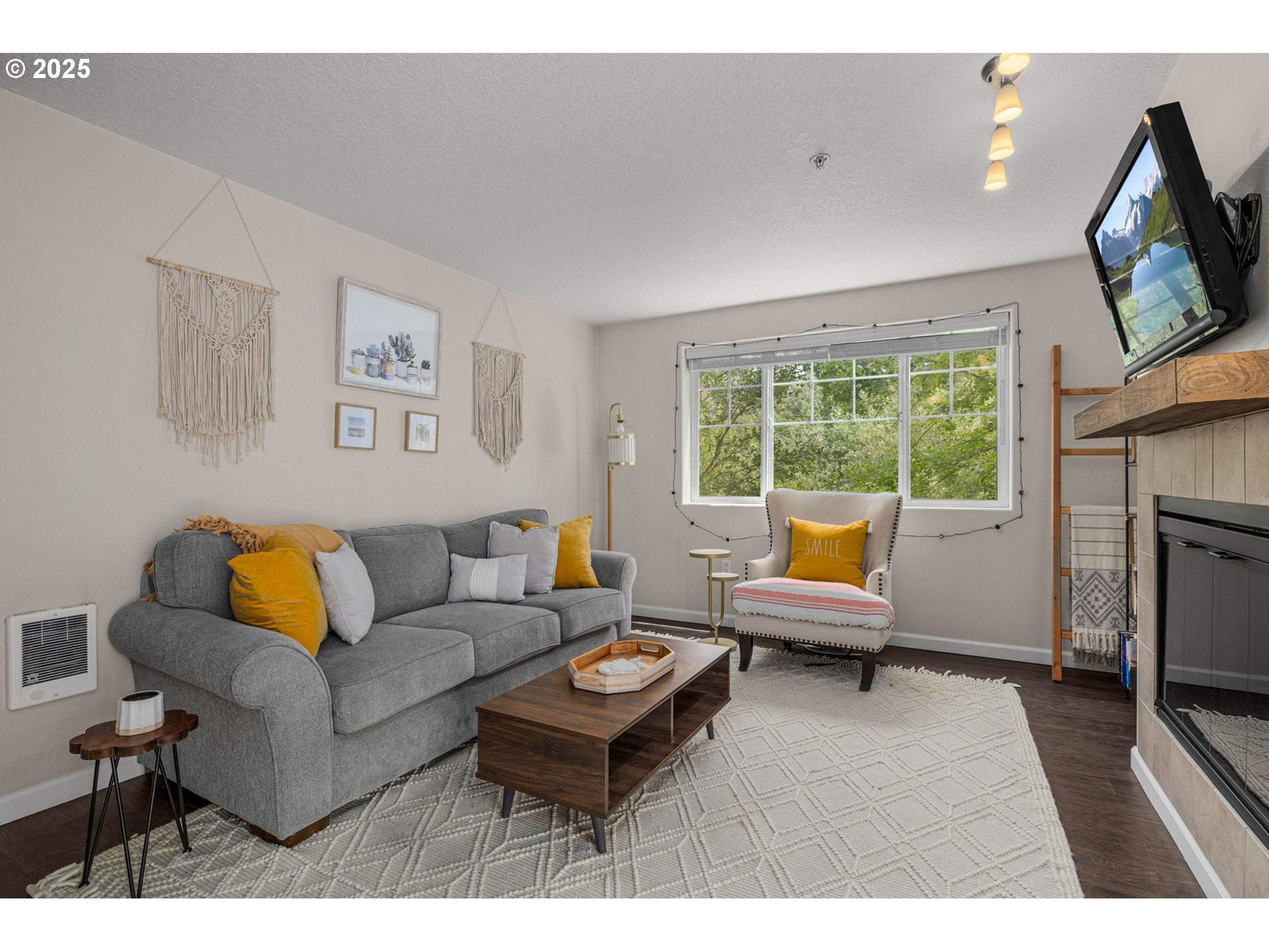 780 Northwest 185th Avenue, Unit 207 Beaverton, OR 97006 - Photo 7 of 29 a living room with furniture tv and a fireplace