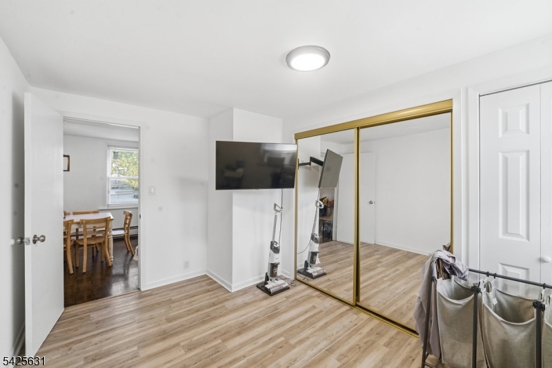 60 Westervelt Place Lodi, NJ 07644 - Photo 25 of 48 a view of a livingroom with wooden floor and staircase
