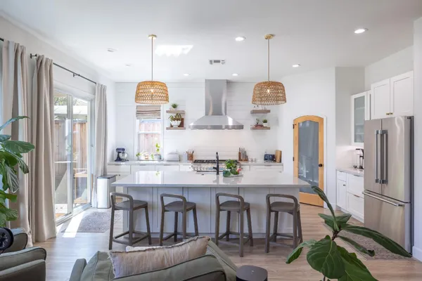 a kitchen with stainless steel appliances granite countertop a stove and a white cabinets