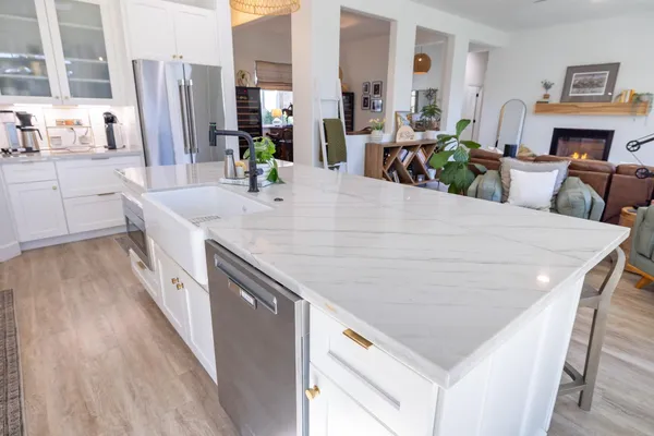 a kitchen with stainless steel appliances granite countertop a refrigerator and a sink