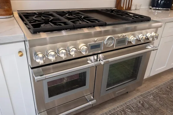 a view of hallway with furniture and wooden floor